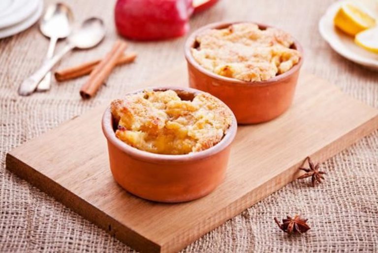 Mini apple crumble pots served warm with golden topping in small ramekins